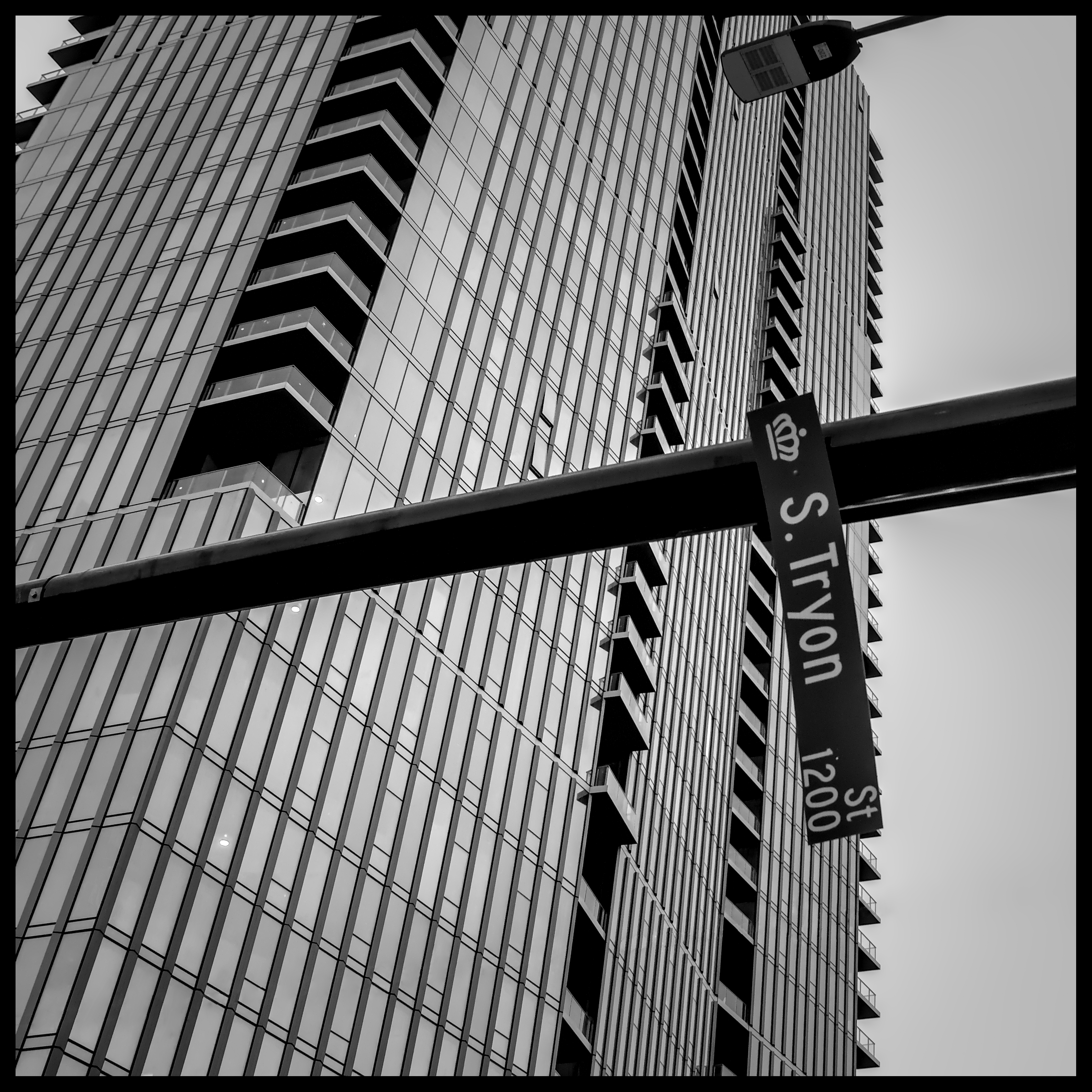 Tryon street sign hanging by a thread